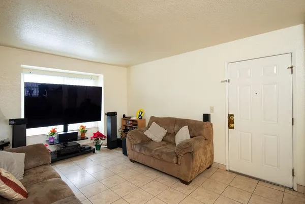 a kitchen with stainless steel appliances granite countertop a stove a refrigerator a kitchen island a table and chairs