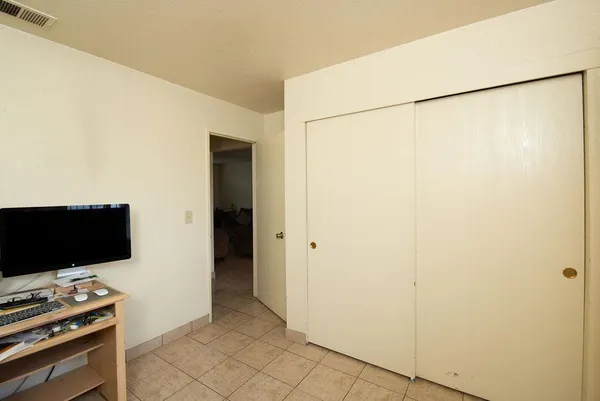a bedroom with a bed and a dresser