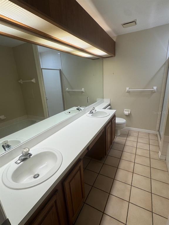 40 Austin Place Oldsmar, FL 34677 - Photo 12 of 26 a bathroom with a sink a toilet and a mirror