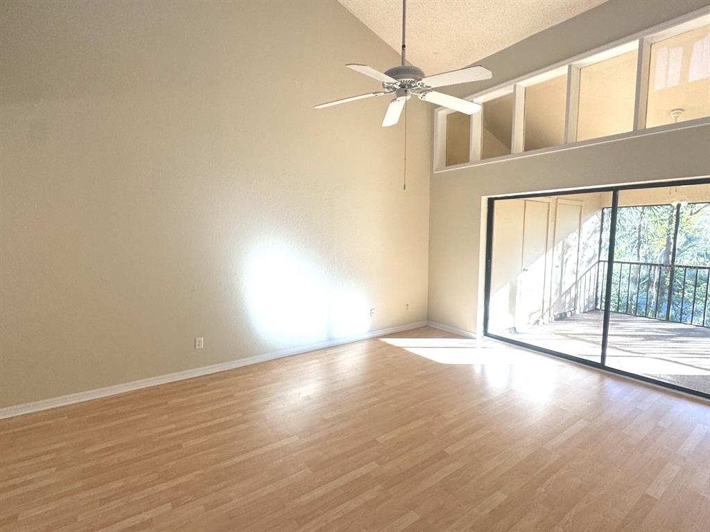 40 Austin Place Oldsmar, FL 34677 - Photo 15 of 26 a view of an empty room with wooden floor and a window