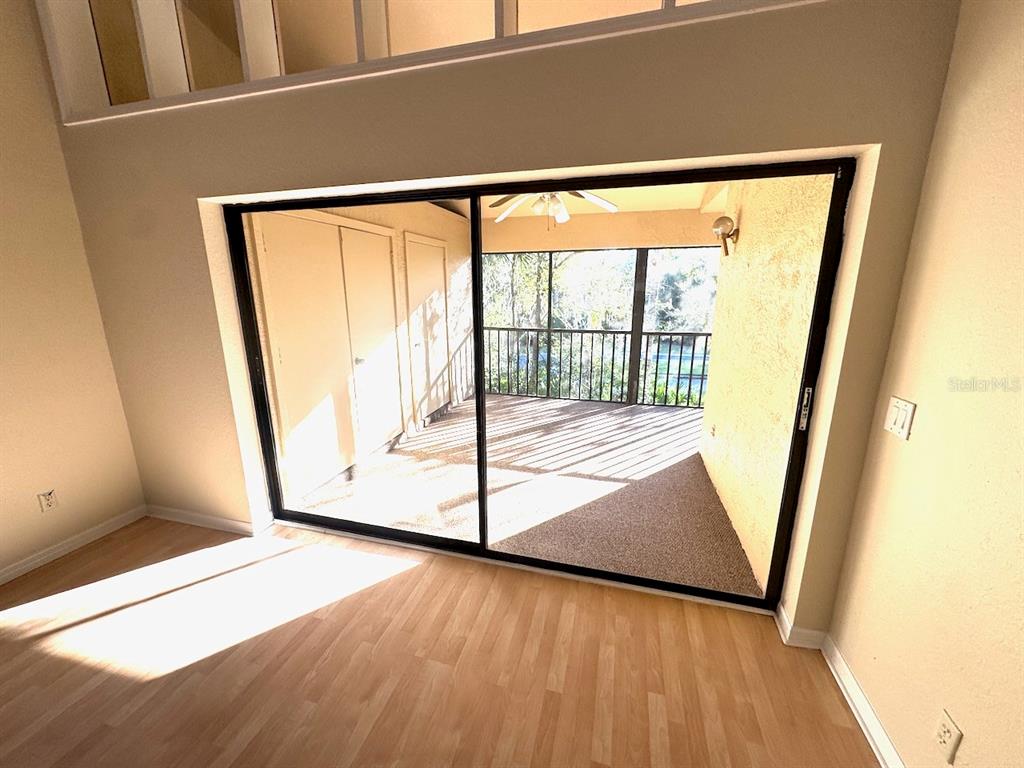40 Austin Place Oldsmar, FL 34677 - Photo 23 of 26 a view of an empty room with wooden floor and a window