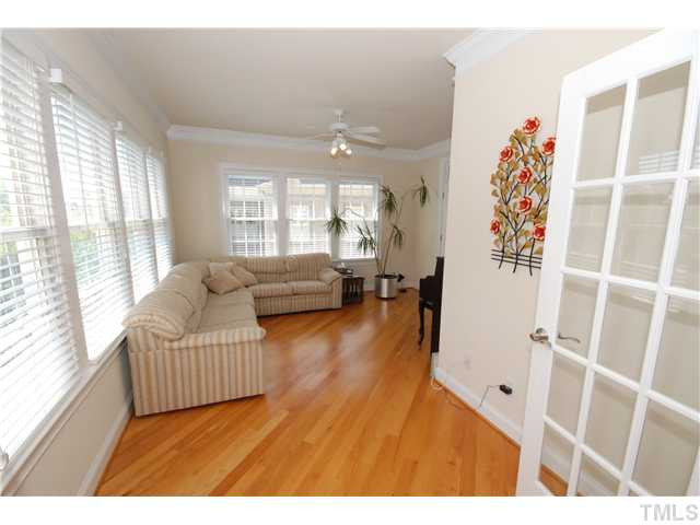 The Sun Room is also filled with tons of light, windows, hardwood flooring! French doors lead to the formal living room/office area Sun Room