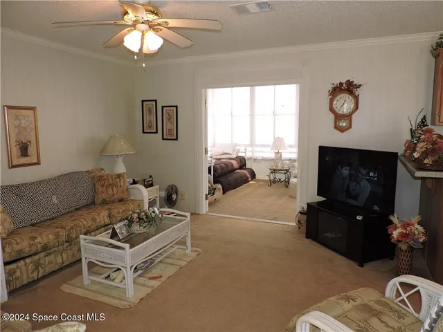 a living room with furniture a fireplace and a window