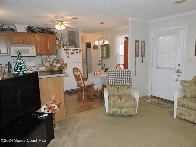 a view of a livingroom with furniture and a flat screen tv