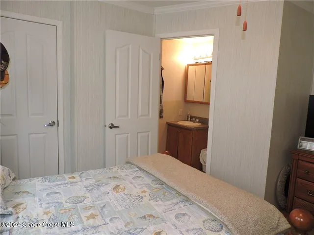 a bedroom with a bed and a mirror