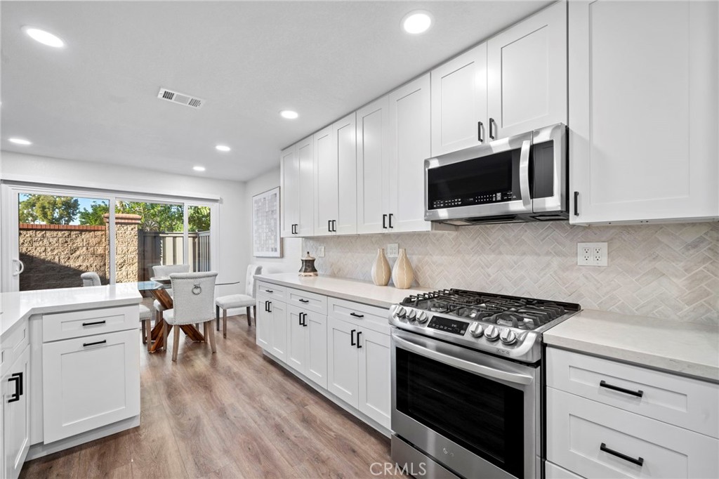 13615 Almond Street Tustin, CA 92782 - Photo 12 of 54 a kitchen with a stove a sink and a microwave