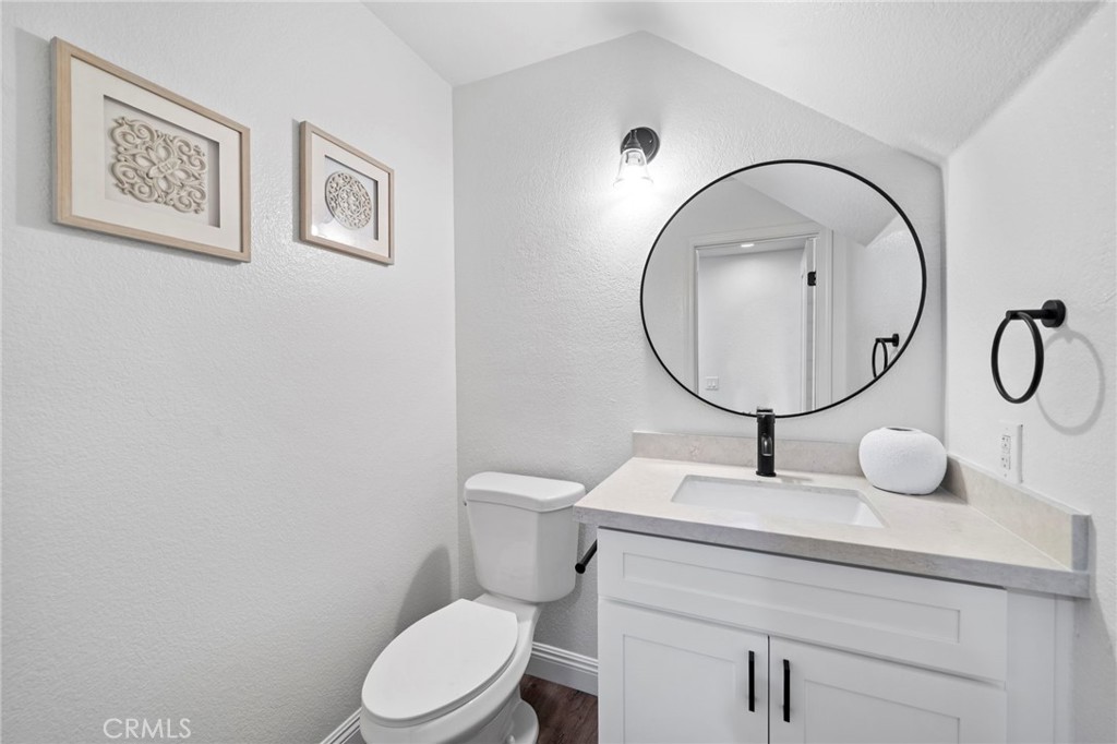 13615 Almond Street Tustin, CA 92782 - Photo 14 of 54 a bathroom with a toilet a sink and mirror