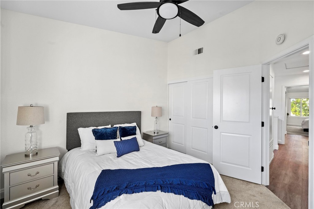 13615 Almond Street Tustin, CA 92782 - Photo 17 of 54 a bedroom with a bed and a chandelier