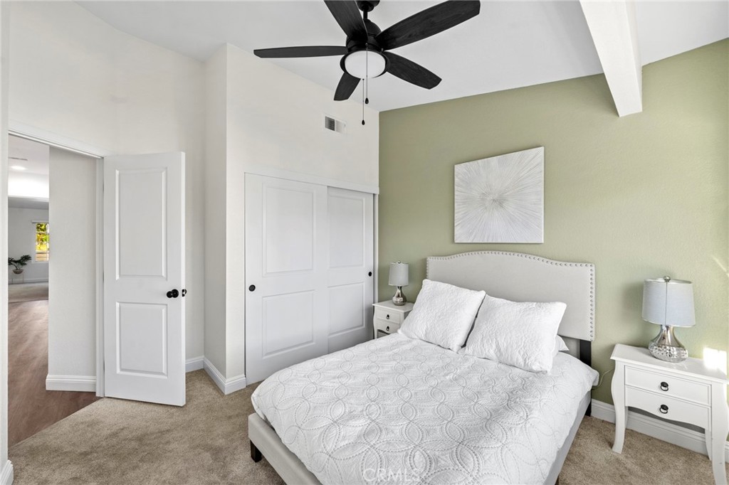 13615 Almond Street Tustin, CA 92782 - Photo 19 of 54 a bedroom with a bed and a chandelier