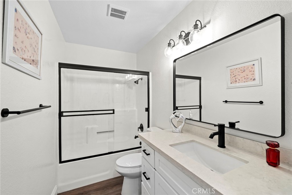 13615 Almond Street Tustin, CA 92782 - Photo 20 of 54 a bathroom with a sink mirror vanity and toilet