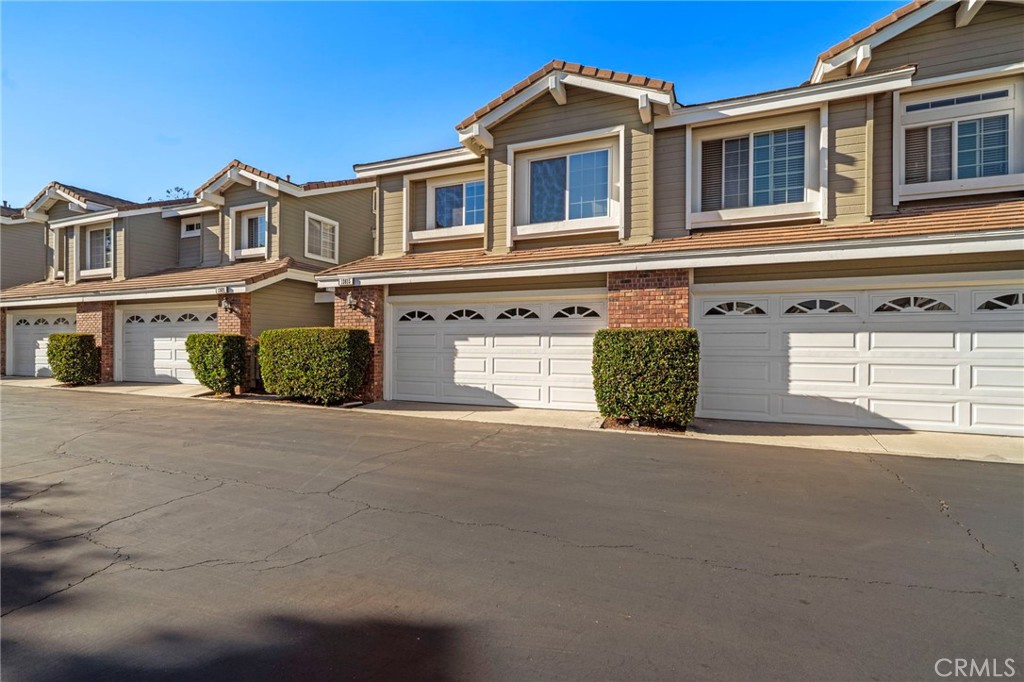 13615 Almond Street Tustin, CA 92782 - Photo 2 of 54 a front view of a house with a road