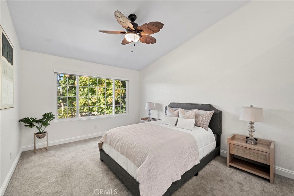 13615 Almond Street Tustin, CA 92782 - Photo 21 of 54 a bedroom with a bed and a chandelier