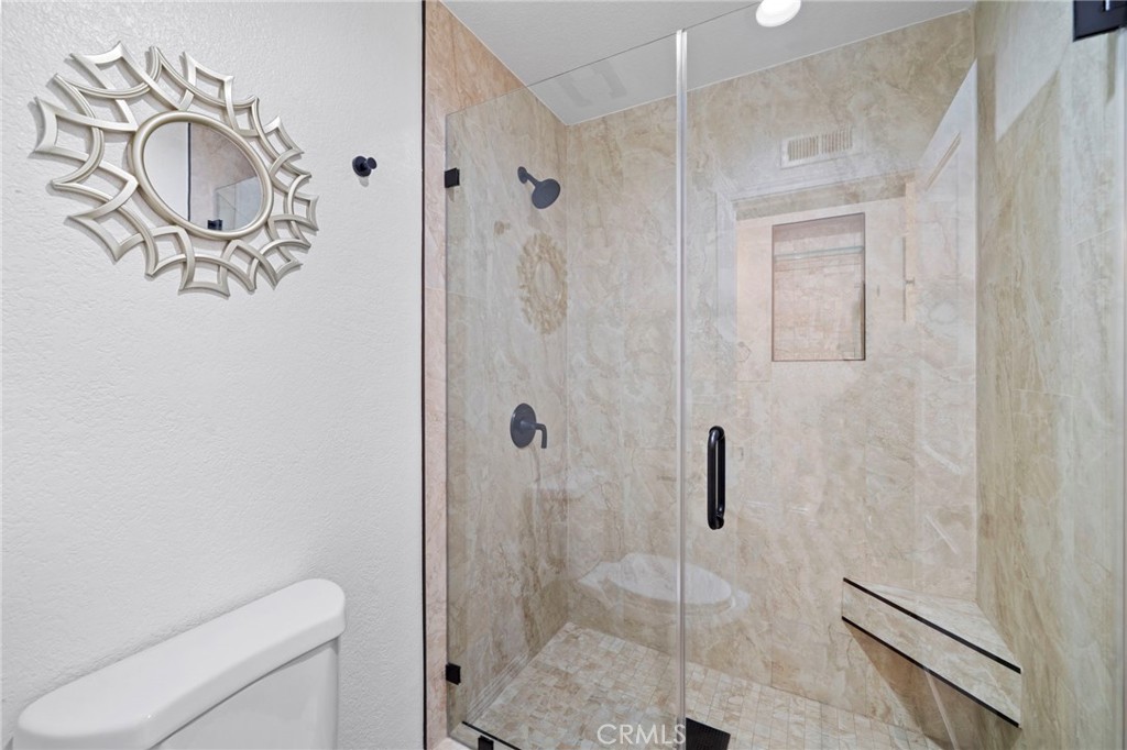 13615 Almond Street Tustin, CA 92782 - Photo 24 of 54 a bathroom with a shower and toilet
