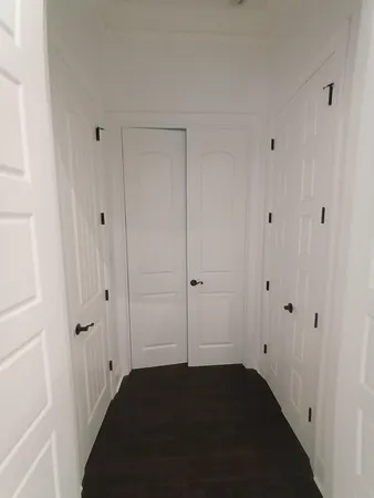 an empty room with a ceiling fan and window