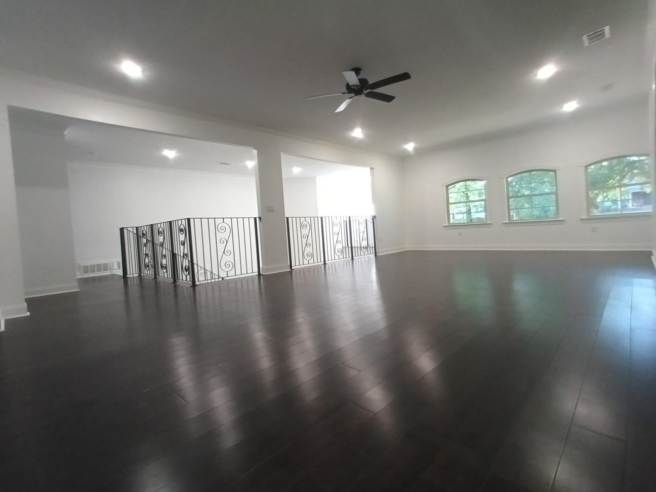 5690 Walnut Grove Road Memphis, TN 38120 - Photo 15 of 40 an empty room with wooden floor and windows