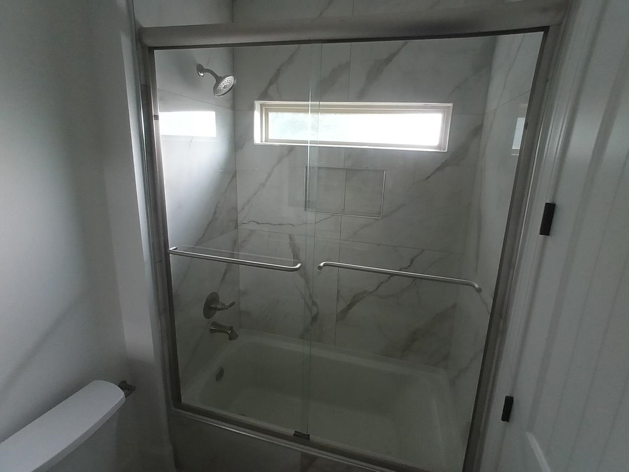 5690 Walnut Grove Road Memphis, TN 38120 - Photo 20 of 40 a bathroom with a glass shower door