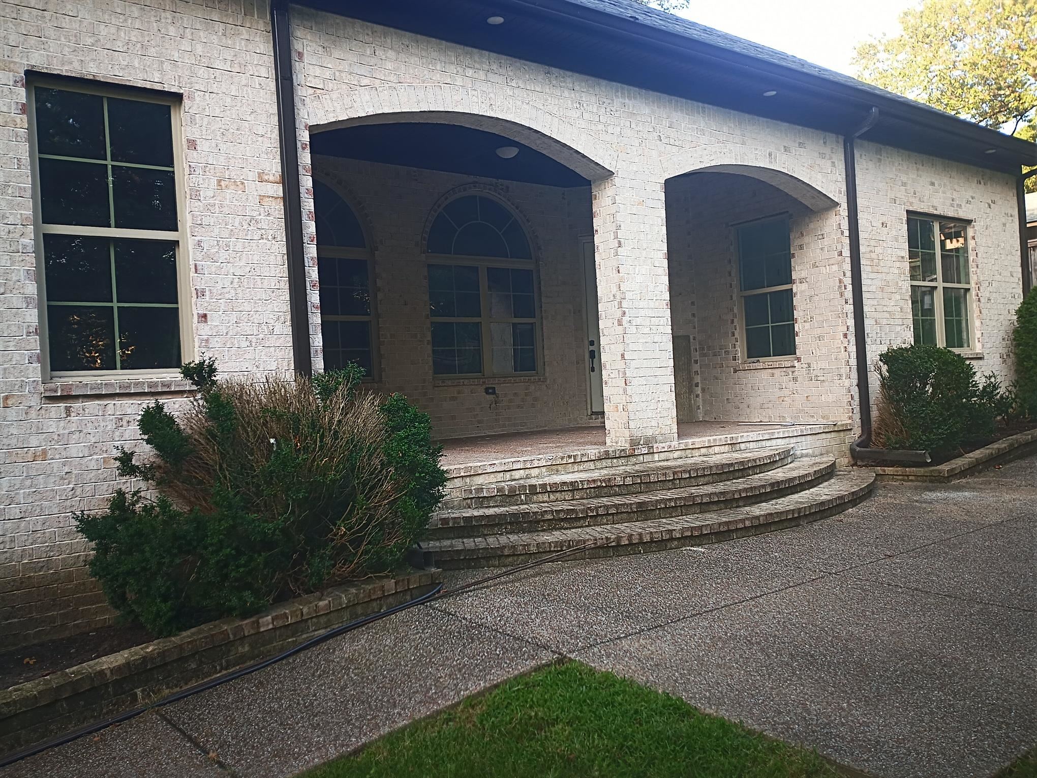 5690 Walnut Grove Road Memphis, TN 38120 - Photo 2 of 40 a front view of a house with a garden
