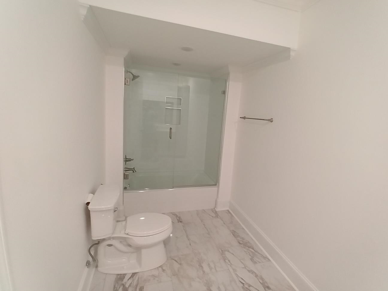 5690 Walnut Grove Road Memphis, TN 38120 - Photo 3 of 40 a bathroom with a granite countertop toilet and a shower