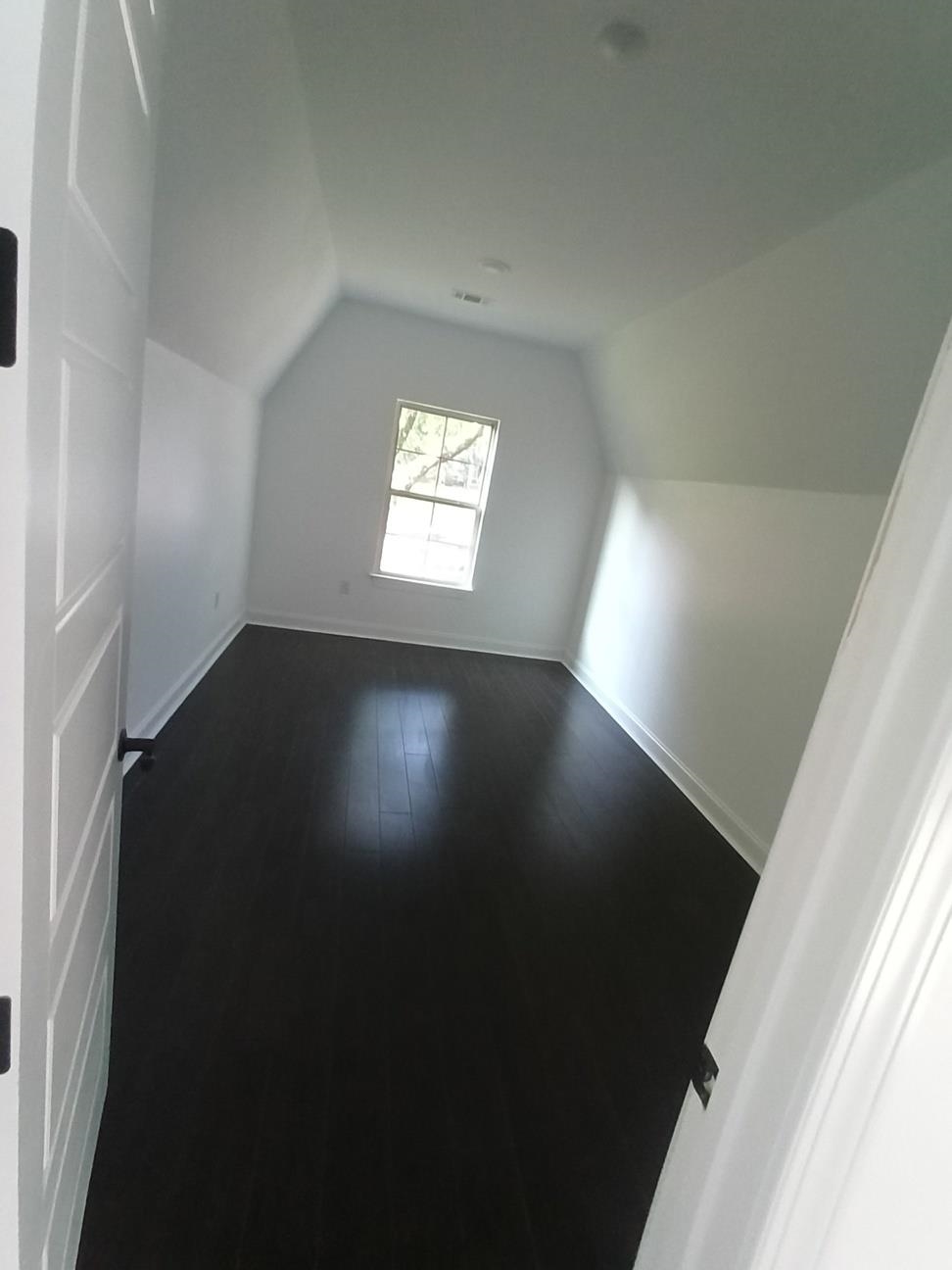 5690 Walnut Grove Road Memphis, TN 38120 - Photo 5 of 40 wooden floor in an empty room with a window