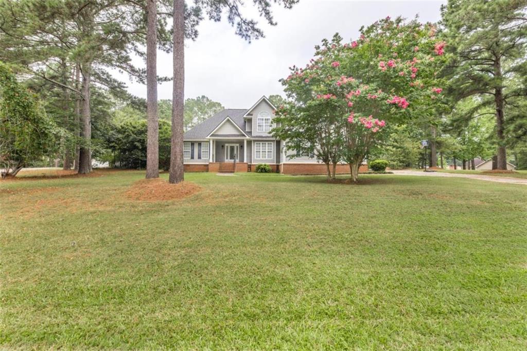 151 Bateman Lane Gray, GA 31032 - Photo 1 of 1 a view of a house with a big yard and large trees