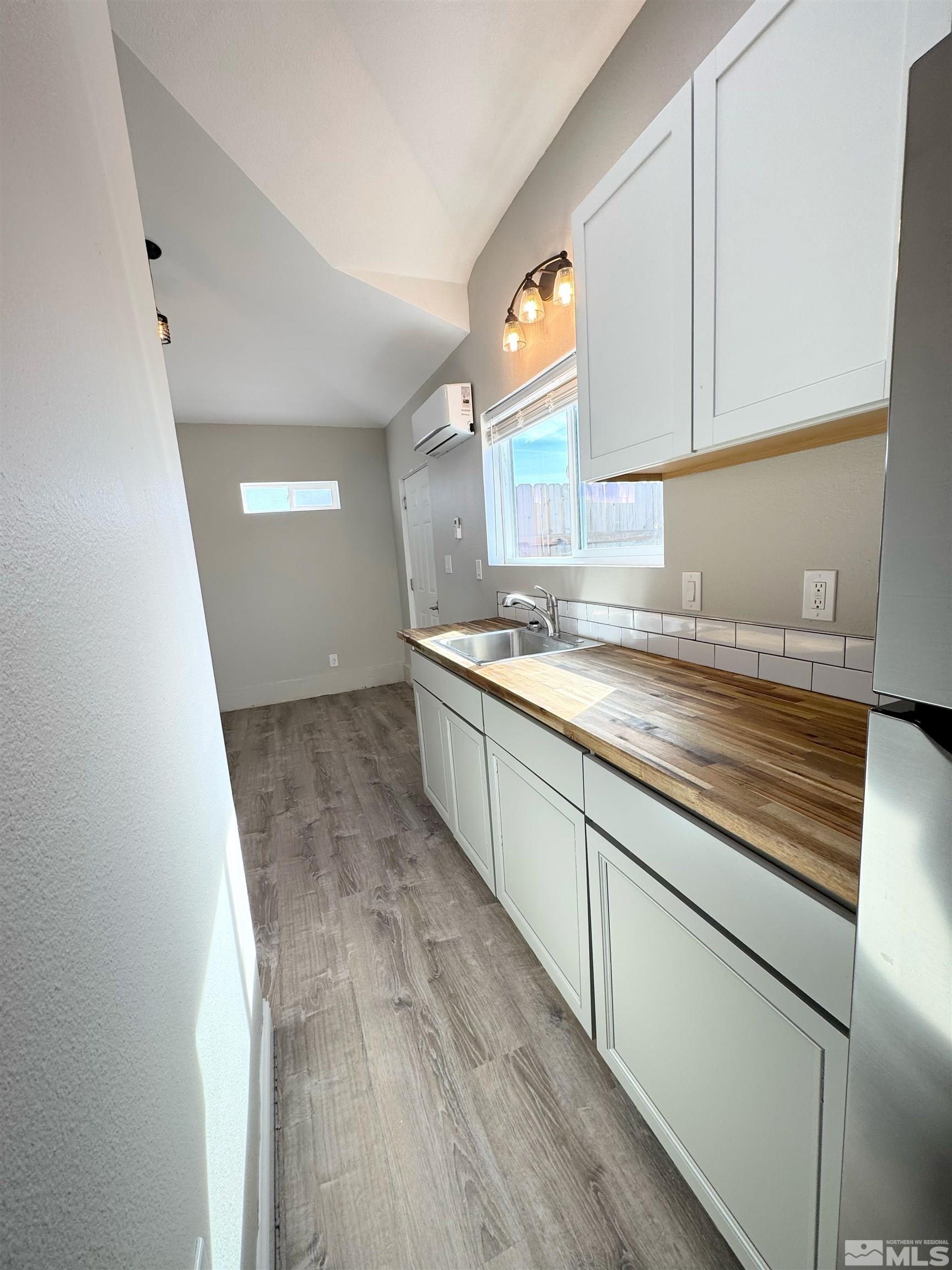 635 Sutro Street Reno, NV 89512 - Photo 13 of 17 a kitchen with granite countertop a sink and a stove top oven