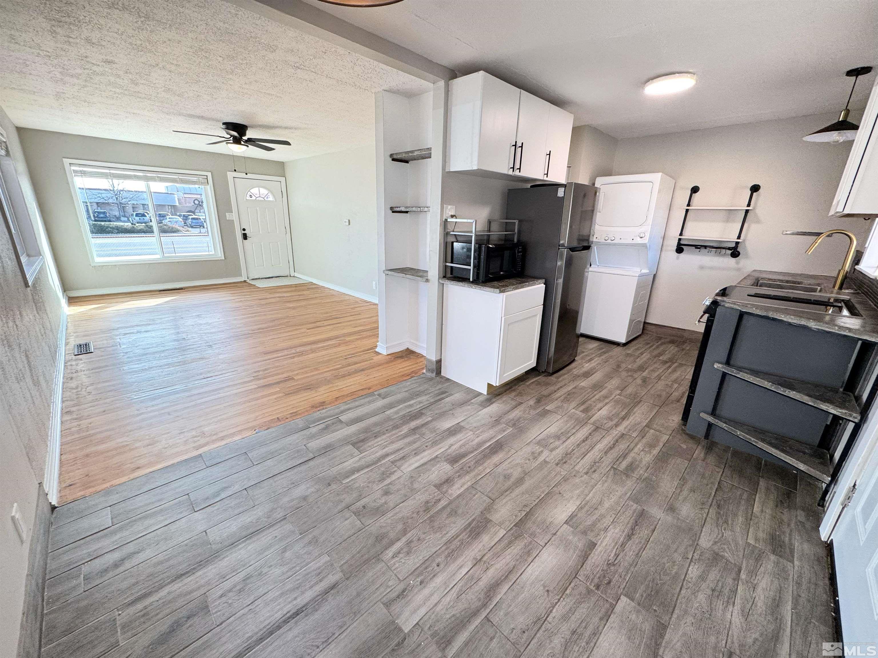 635 Sutro Street Reno, NV 89512 - Photo 3 of 17 a kitchen with stainless steel appliances wooden floors and wooden cabinets
