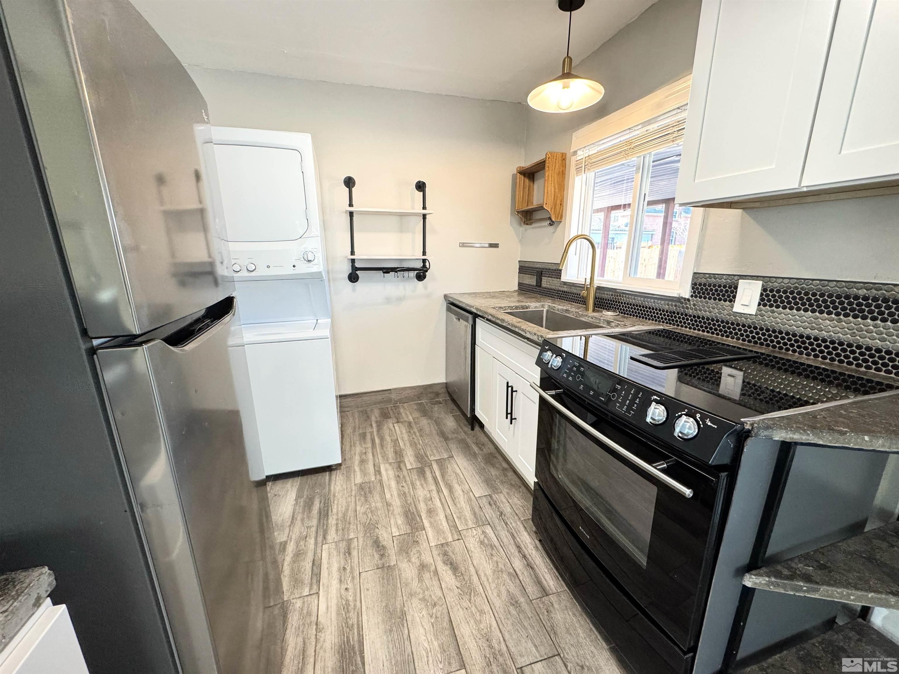 635 Sutro Street Reno, NV 89512 - Photo 4 of 17 a kitchen with stainless steel appliances a stove a sink a refrigerator and cabinets