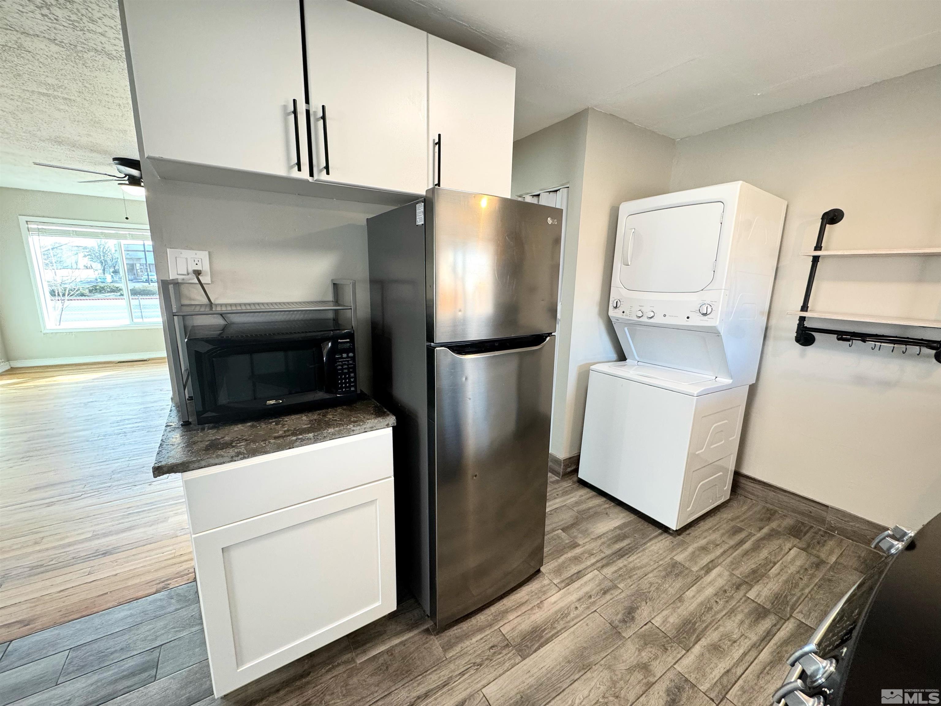 635 Sutro Street Reno, NV 89512 - Photo 6 of 17 a kitchen with stainless steel appliances granite countertop a refrigerator a stove and a wooden floors