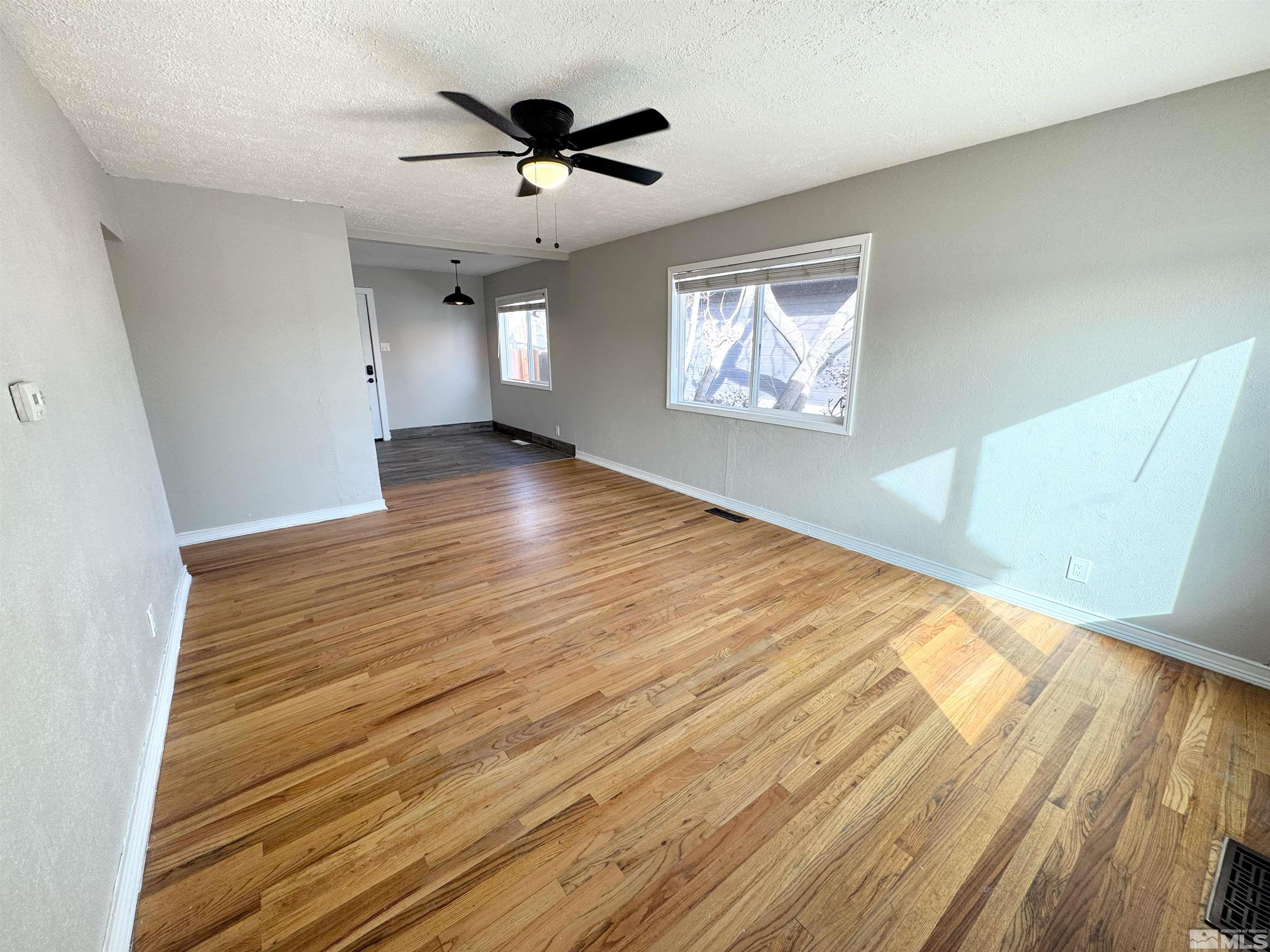 635 Sutro Street Reno, NV 89512 - Photo 8 of 17 wooden floor in an empty room with a window