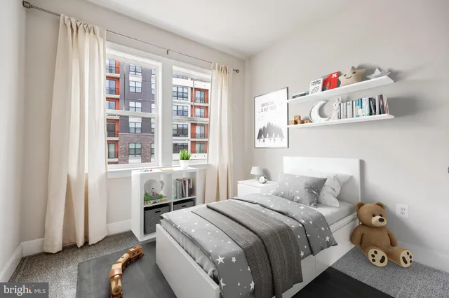 a view of an empty room and a kitchen