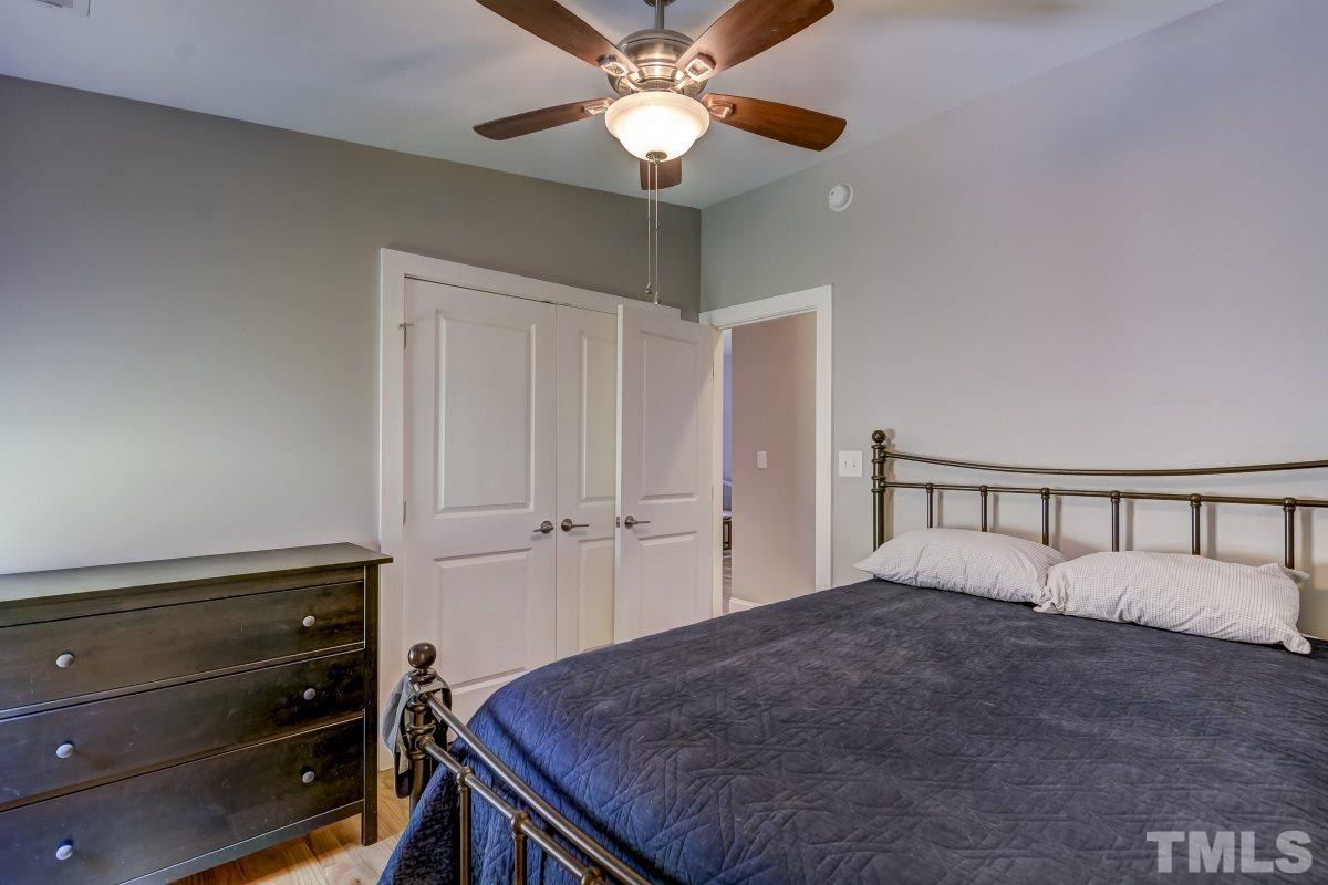 520 Alston Street Raleigh, NC 27601 - Photo 6 of 15 a bed room with a bed and a ceiling fan