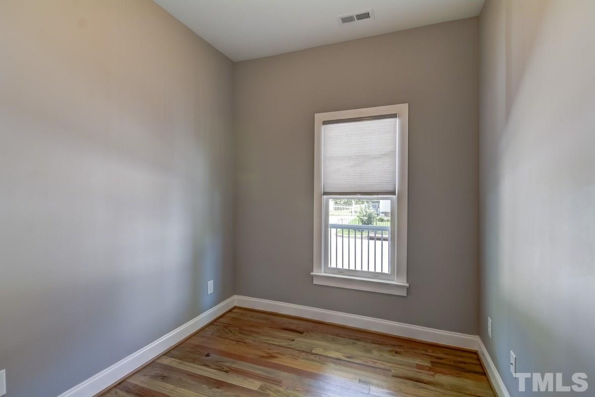 520 Alston Street Raleigh, NC 27601 - Photo 10 of 15 a view of an empty room with wooden floor and a window