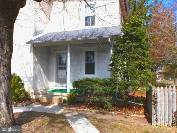a view of a brick house with a large windows and plants