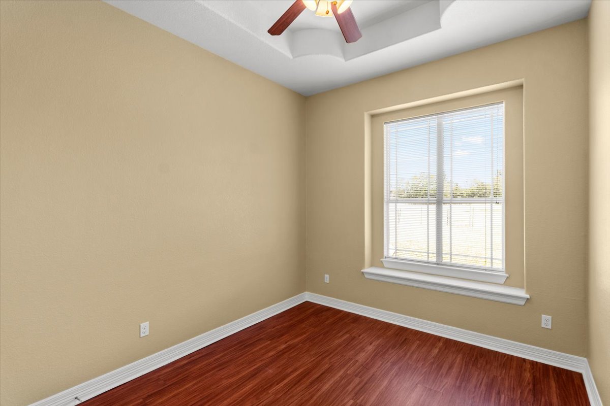 437 Balch Road Elgin, TX 78621 - Photo 18 of 37 Bright hardwood floors and a ceiling fan complete this versatile interior space.