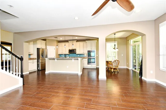 a view of a livingroom with furniture and a kitchen view