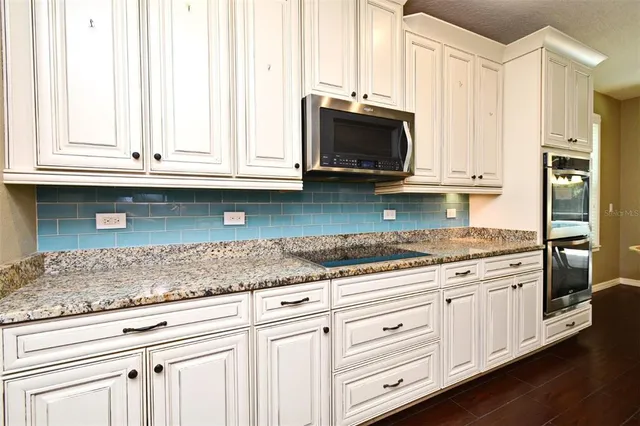 a kitchen with appliances cabinets and a counter top space