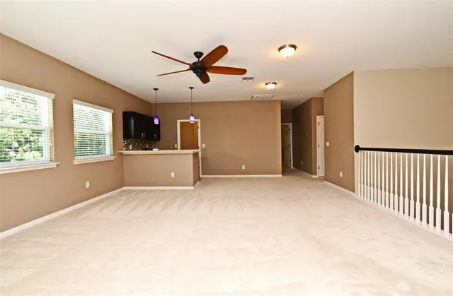a view of a hallway with a ceiling fan