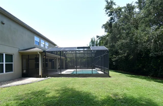 a view of a house with backyard and porch