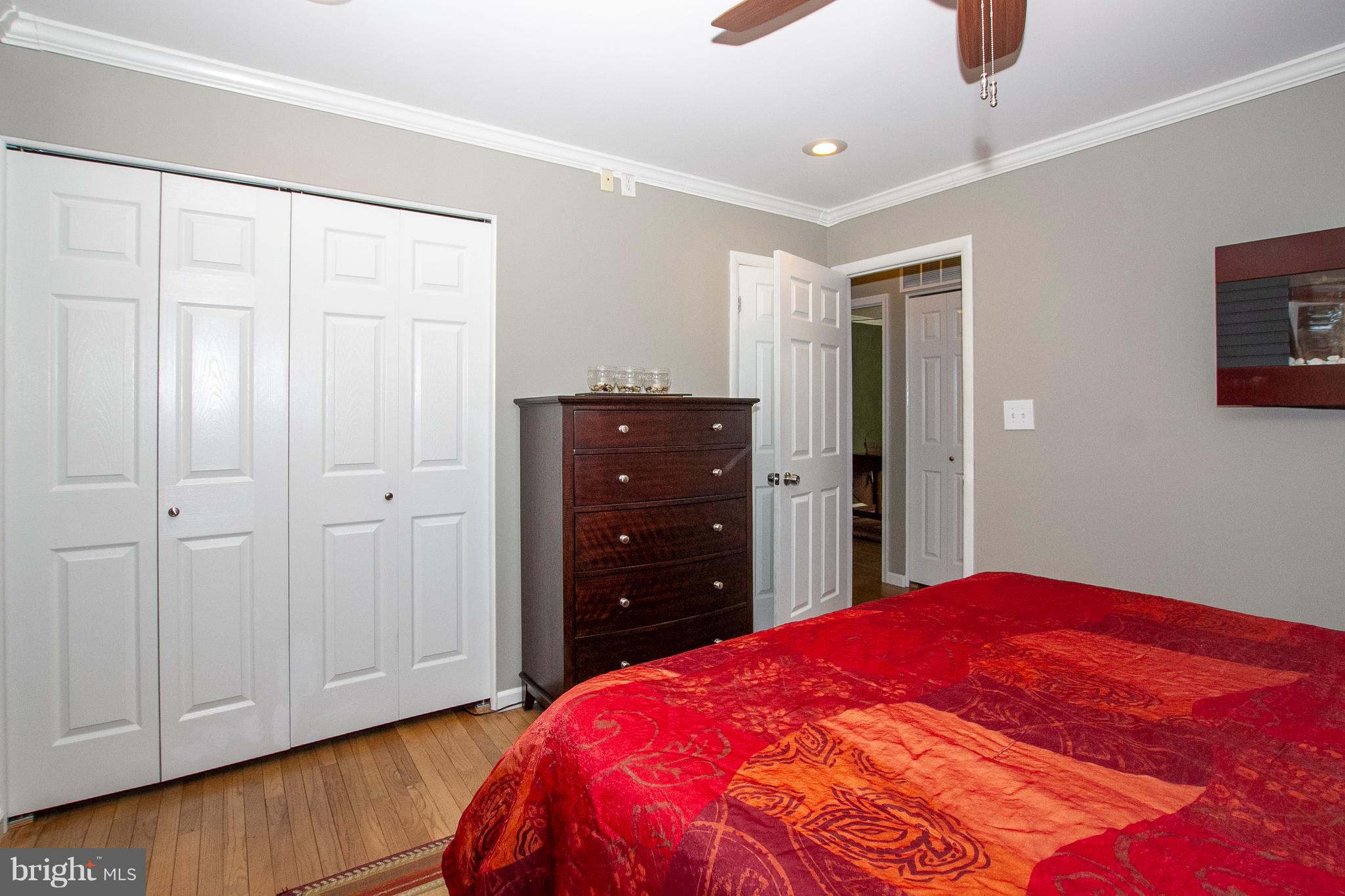 1904 Logwind Road Catonsville, MD 21228 - Photo 14 of 34 a bedroom with a bed and a dresser