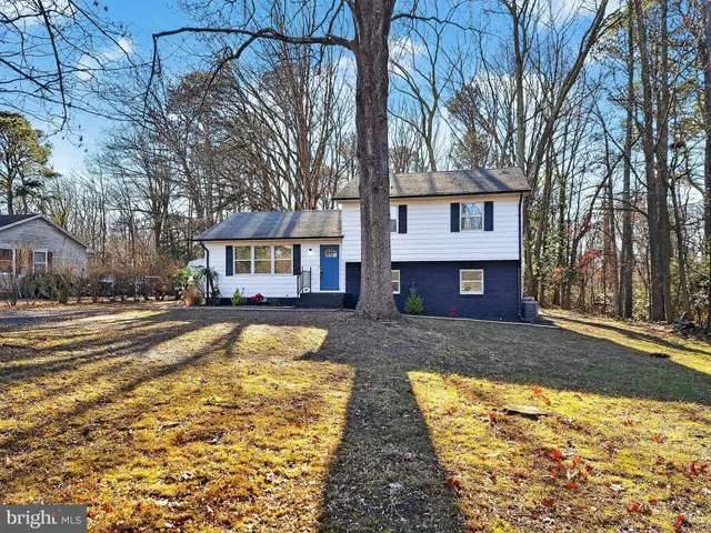 a view of a house with a yard covered in snow