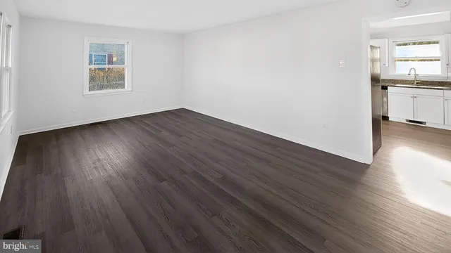 a view of a kitchen with wooden floor and a sink