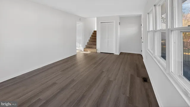 a view of a room with wooden floor and entryway