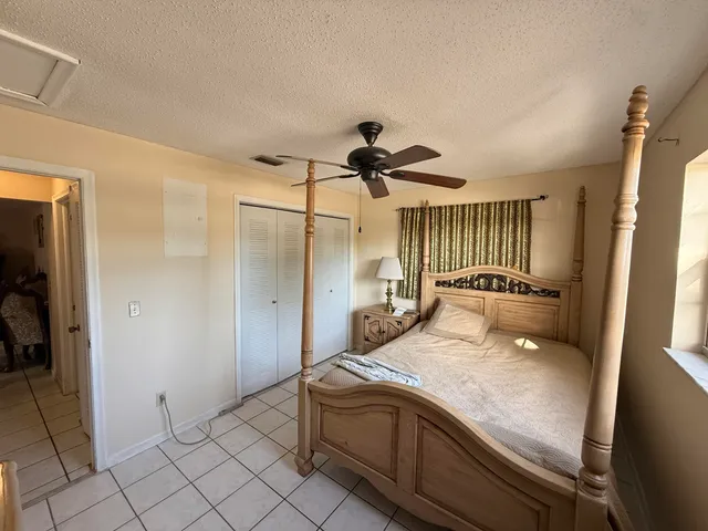a en suite bathroom with a granite countertop sink and a mirror