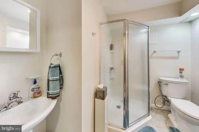 a view of patio with chairs and table under an umbrella
