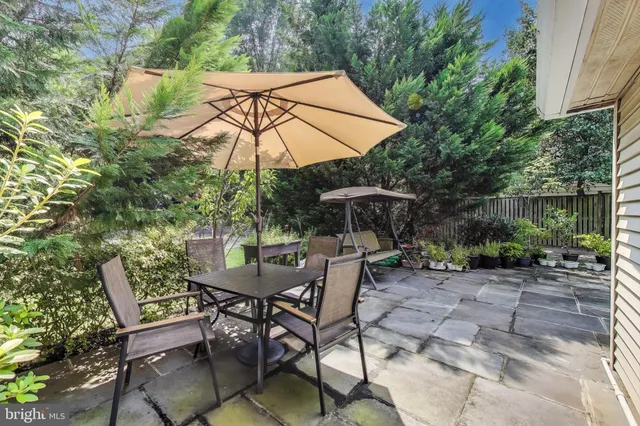 a view of a house with backyard sitting area and garden