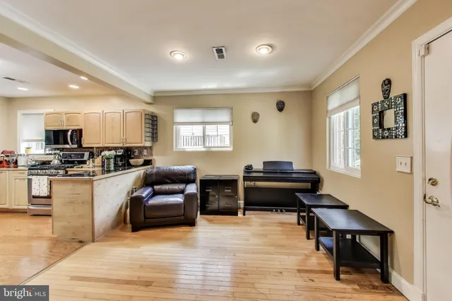 a large kitchen with stainless steel appliances granite countertop a stove and a sink