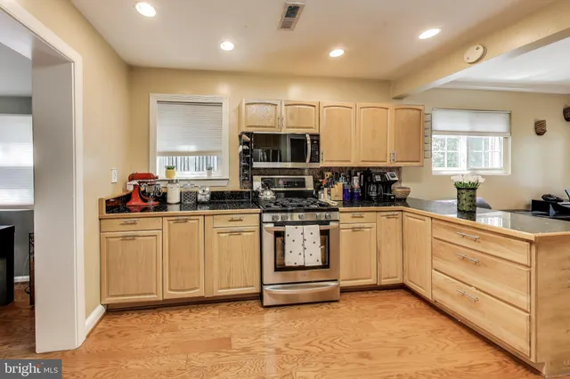 a view of a dining room with furniture and a window
