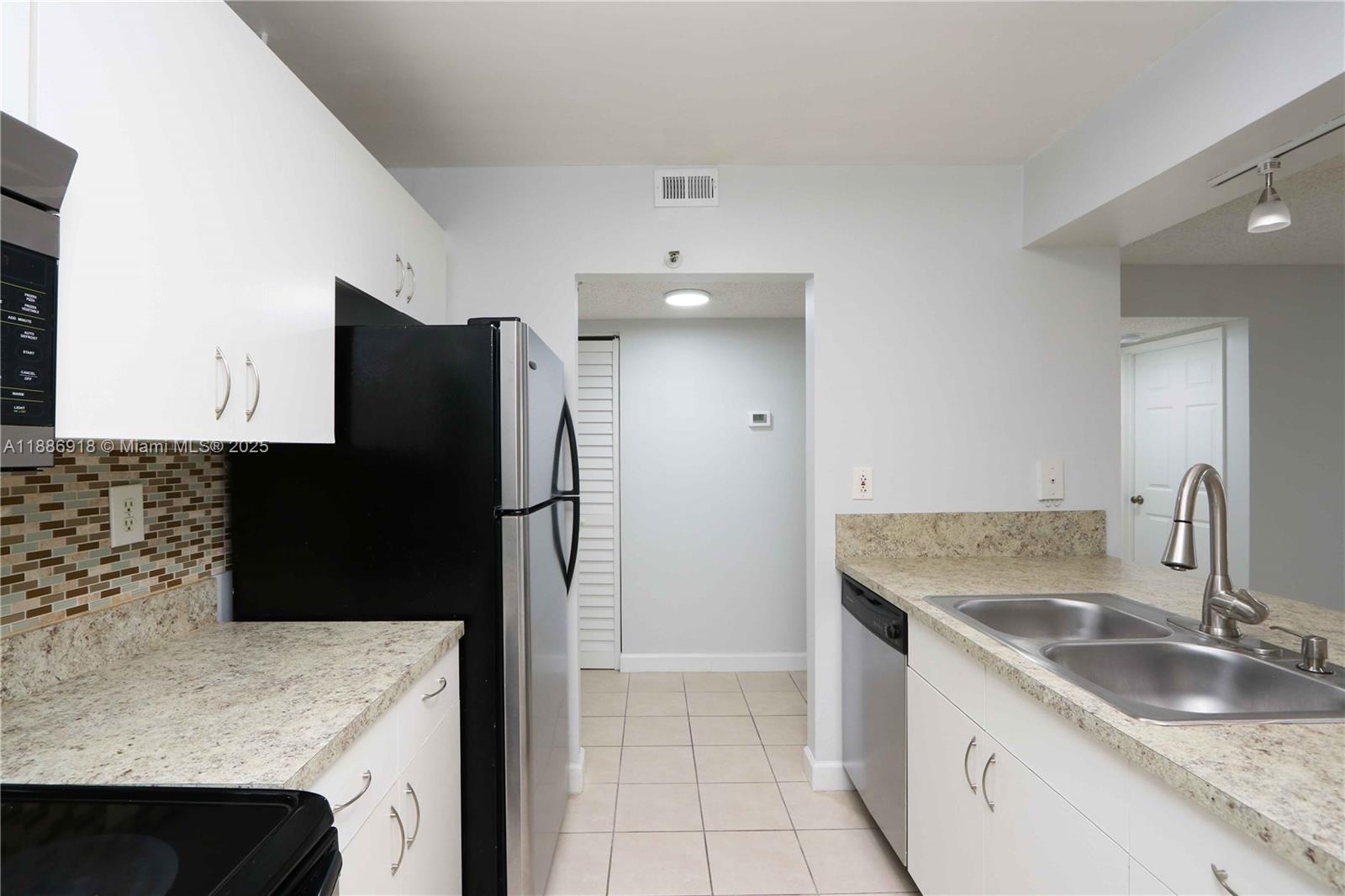 850 North Miami Avenue, Unit W305 Miami, FL 33136 - Photo 13 of 27 a kitchen with stainless steel appliances granite countertop a sink stove and refrigerator