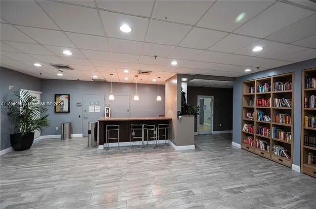 a view of a livingroom with furniture and a bookshelf