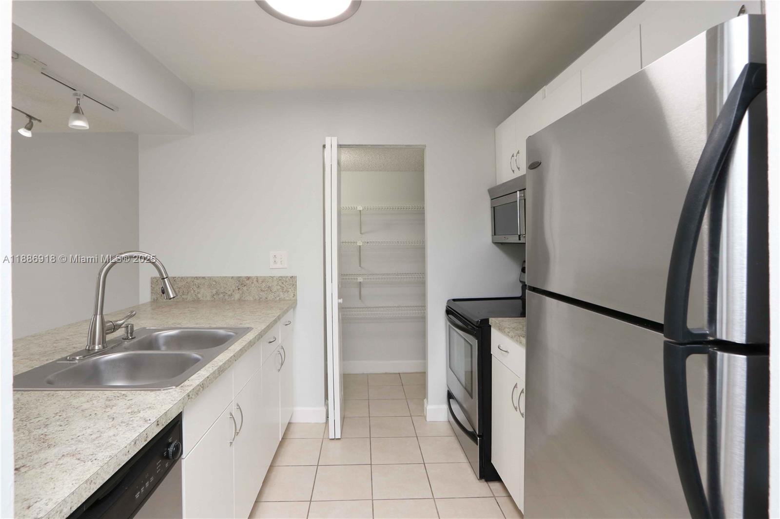 850 North Miami Avenue, Unit W305 Miami, FL 33136 - Photo 3 of 27 a kitchen with stainless steel appliances granite countertop a refrigerator and a sink